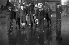 Children on village pond learn to skate