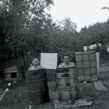 Farmers enjoy a cool bath in the barrels after hard work