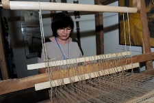 Weaver at the weaving loom in the Pomeranian Folk Culture Museum in Swołowo