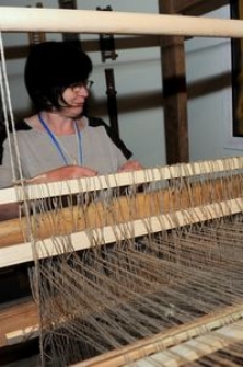 Weaver at the weaving loom in the Pomeranian Folk Culture Museum in Swołowo