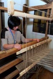 Weaver at the weaving loom in the Pomeranian Folk Culture Museum in Swołowo
