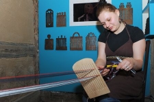 Weaver at the weaving loom in the Pomeranian Folk Culture Museum in Swołowo