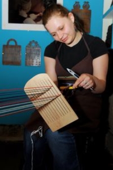 Weaver at the weaving loom in the Pomeranian Folk Culture Museum in Swołowo