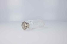 Szesnastokątna na planie koła szklana flaszka z nakrętką zmonogramem MG